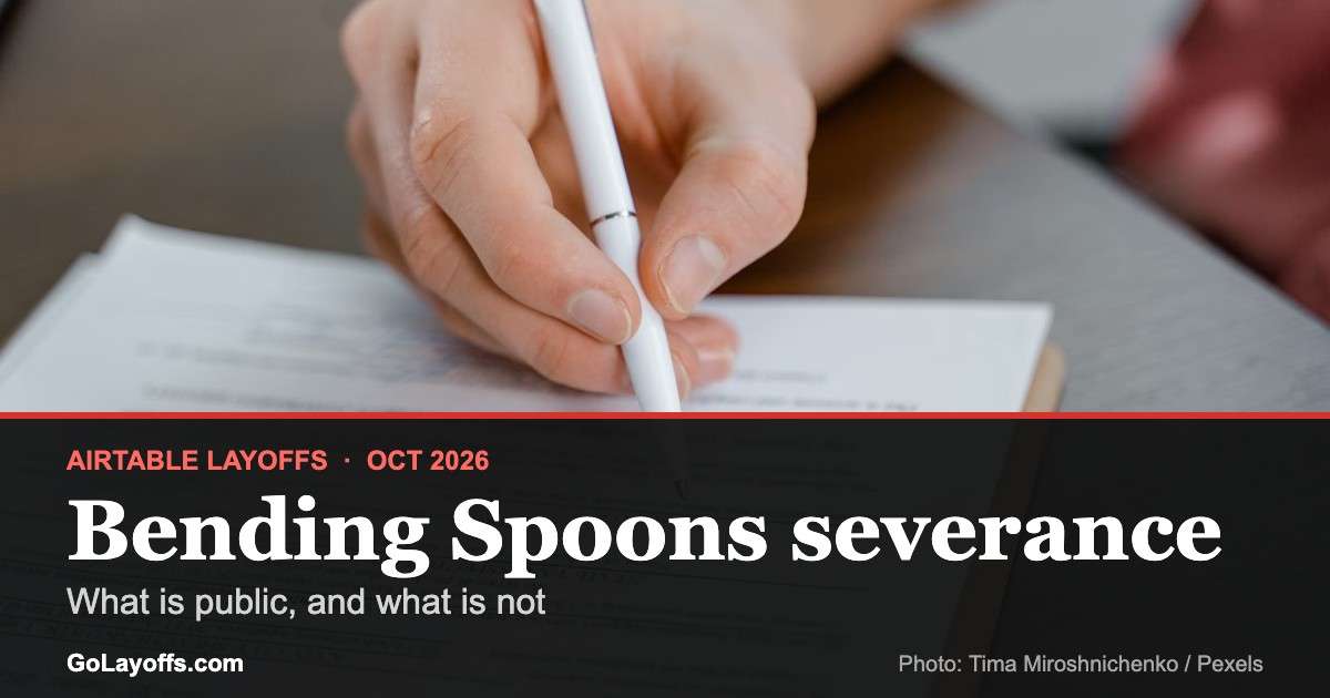 Hand holding a pen over a document to sign