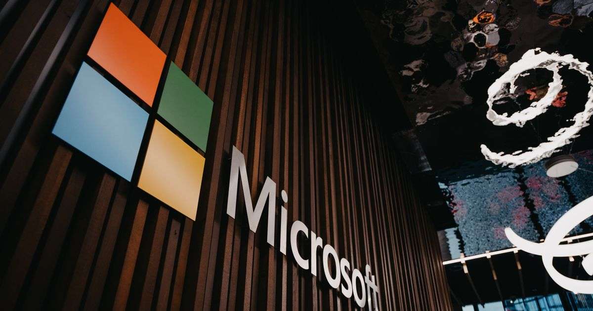 Microsoft logo on a wooden wall inside a Microsoft office