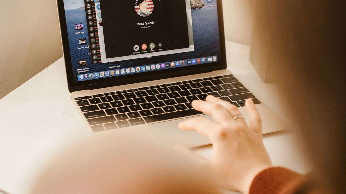 A person on a video call using a laptop